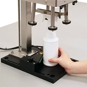 Spindle capper with Bottle Activated Backstop