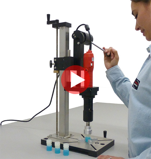ES Table Top Capping Equipment with bottle on the base and against the backstop